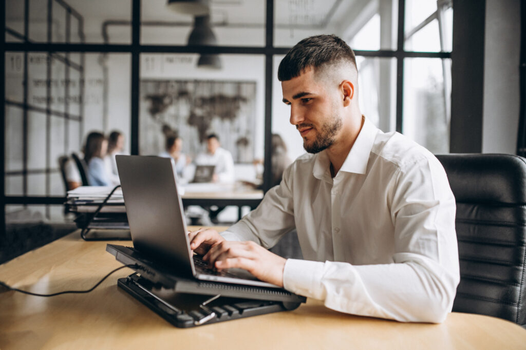 Man working on laptop in it staffing company