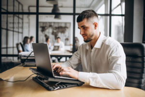 Man working on laptop in it staffing company